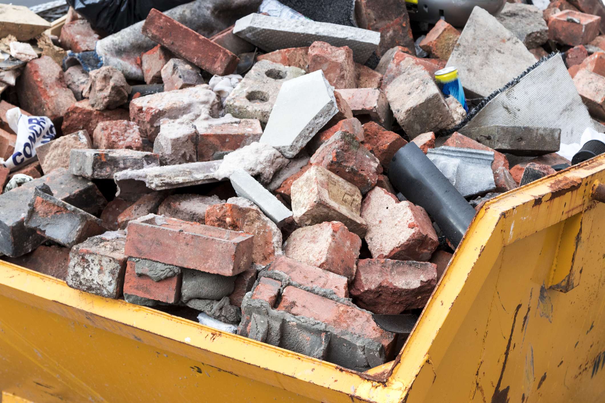 demolition dumpster full of bricks and waste
